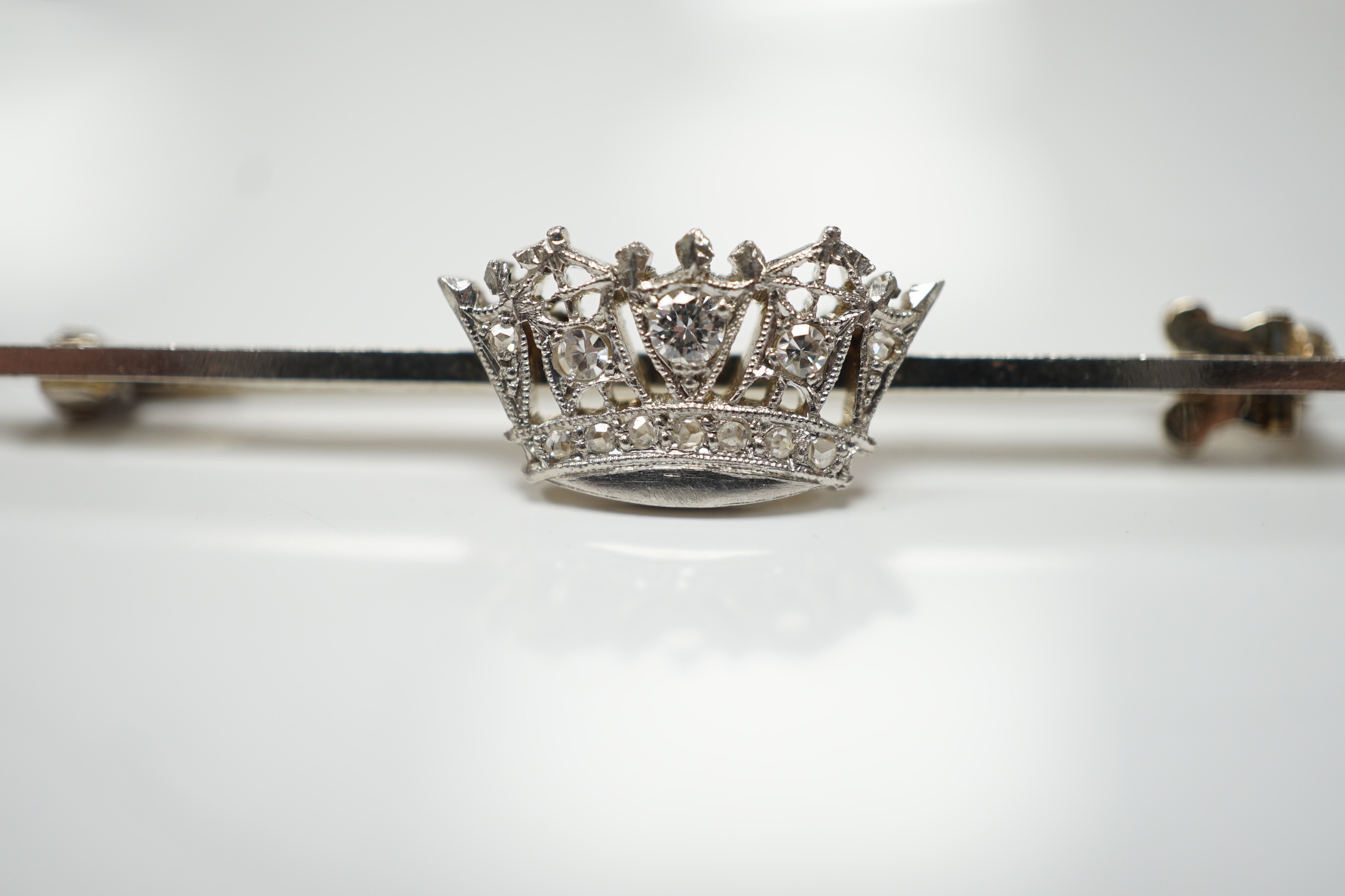 A 1940's white metal (stamped 14ct and platinum) and diamond cluster set coronet bar brooch, 50mm, gross weight 4.1 grams.